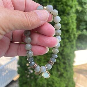 Green beaded stretch bracelet with hanging charm.